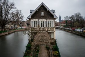 old building surrounded by water greenery cloudy sky strasbourg france 1 1627640164 80.90.95.248